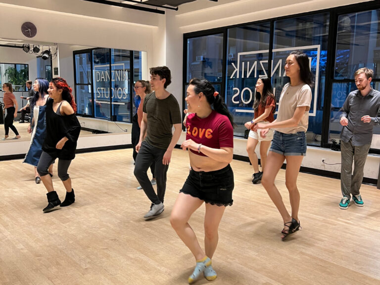 Beginner line dancers practicing at Danznik Studios in a spacious dance room.